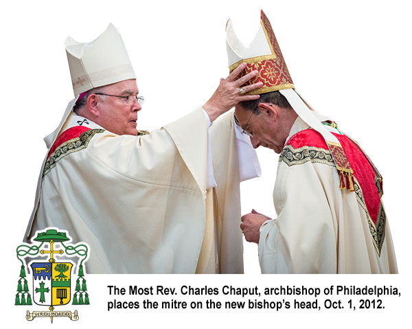 The Most Rev. Charles Chaput, archbishop of Philadelphia, places the mitre on the new bishop’s head, Oct. 1, 2012.