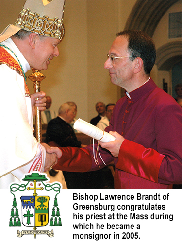Bishop Lawrence Brandt of Greensburg congratulates his priest at the Mass during which he became a monsignor in 2005.